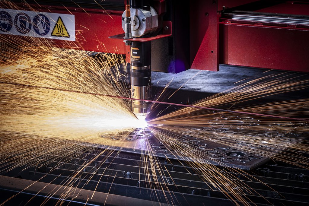 Dramatic photograph of plasma cutting metal with a shower of sparks