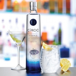 Ciroc Vodka bottle, cocktail glass with grapes and glass with ice and lemon