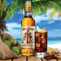 Advertising photograph of a captain Morgan rum bottle and glass served with ice and lemon product photography by Ross Vincent