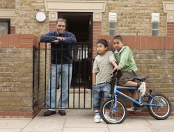 Dad with kids outside social housing