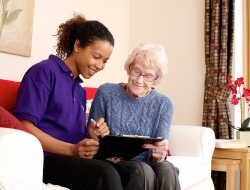 Accord housing staff carer helping resident