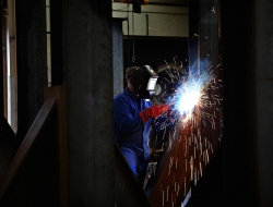 welder with large block of metal-industrial photographic image