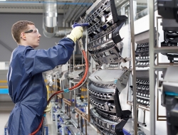 spay painting production with worker using spray gun on range rover car parts-Industrial photography