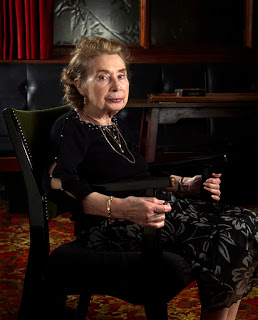 Stoic lady's Agnes, photographic portrait in a chair at a social club, as part of a Documentary personal project Photography by Ross Vincent