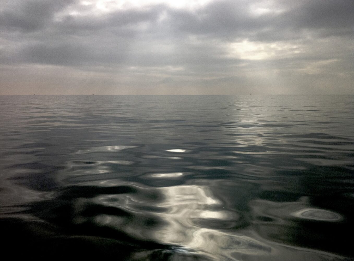 an atmospheric view of dark sea and sky