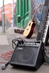 Portable Laney guitar amplifier on the roadside at the Custard Factory, Birmingham with guitar and keyboard in the background