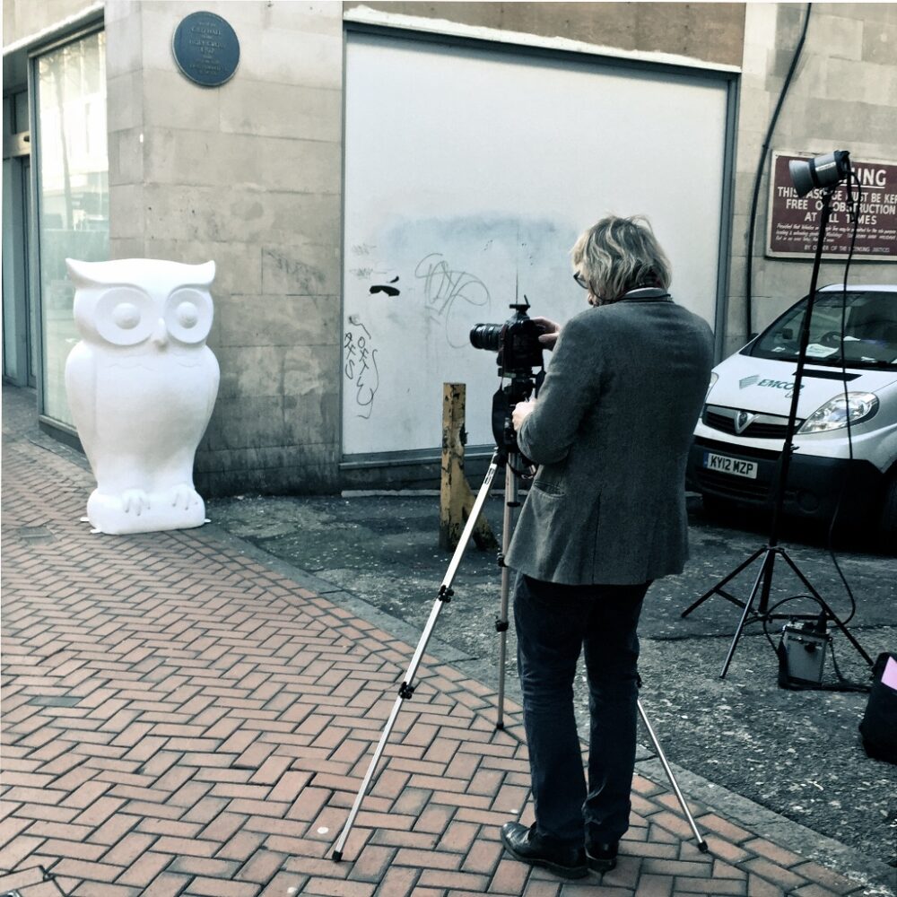 Oversized fiberglass Owl beside Birmingham's New Street, The blue plaque is the site of the first King Edward School, part of a publicity series