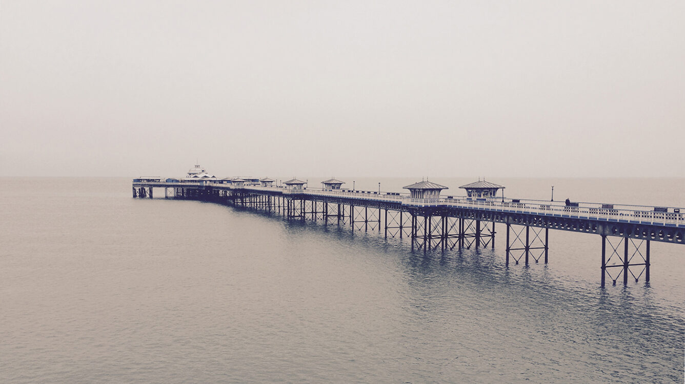 Llandudno Victorian pier North Wales on a misty and cloudy day