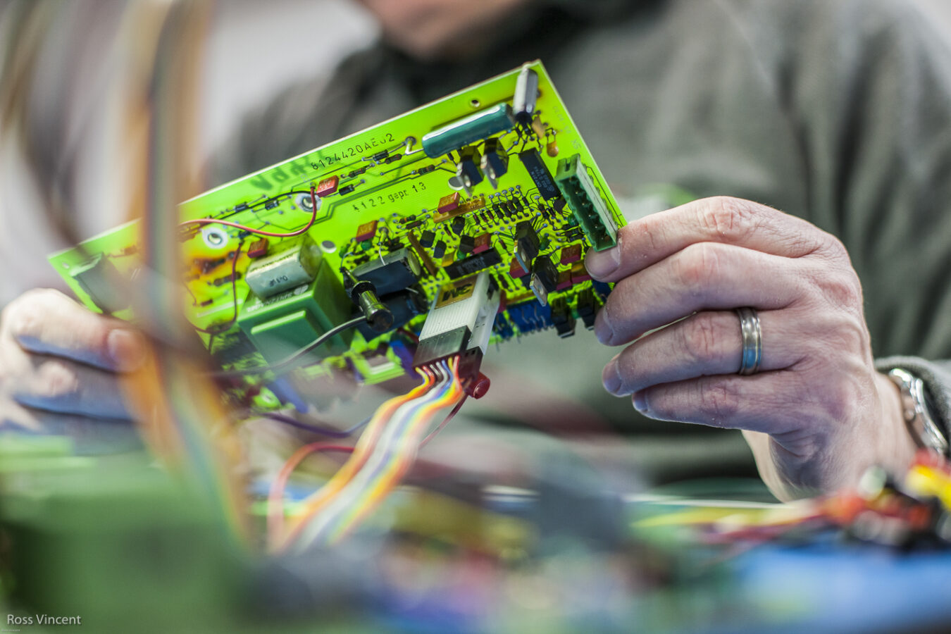 photograph of repair and inspection of a circuit board, close-up detailed image, at Fletcher Moorland, Stoke-on-Trent
